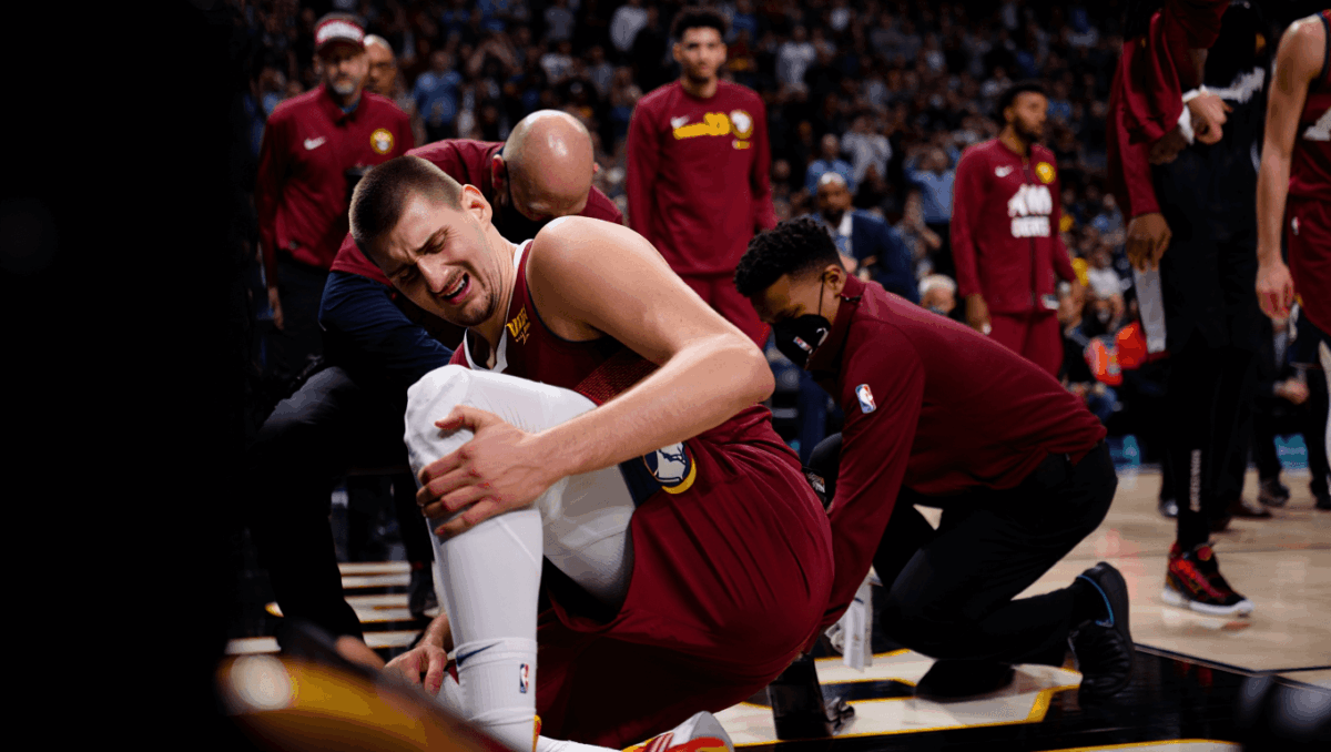 Nikola Jokic limps off court with left knee injury in Nuggets-Heat game, questionable to return