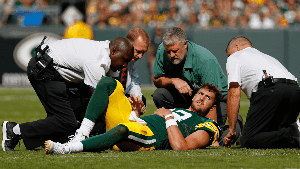 Jordan Love exits game after brutal helmet-to-helmet hit, concussion evaluation underway