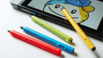 Nintendo Switch console displaying Tomodachi Life: Living the Dream game promotional image with a Bopomofo touch screen stylus overlaid
