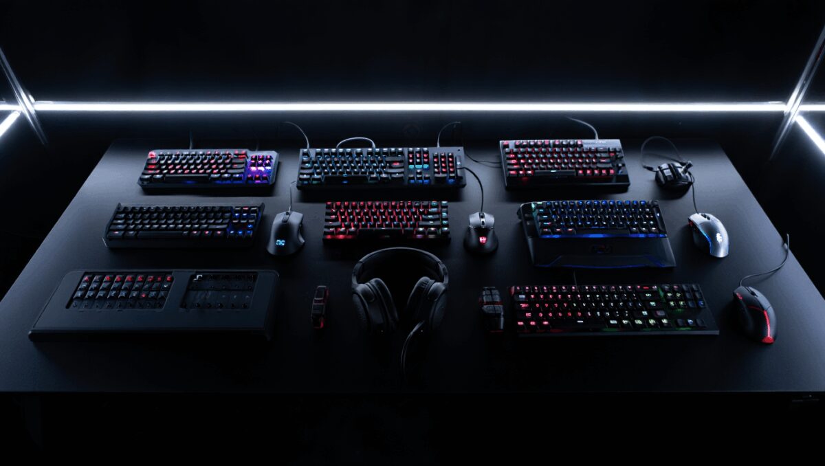 A selection of gaming peripherals, including a mouse, a joypad, and some headphones.