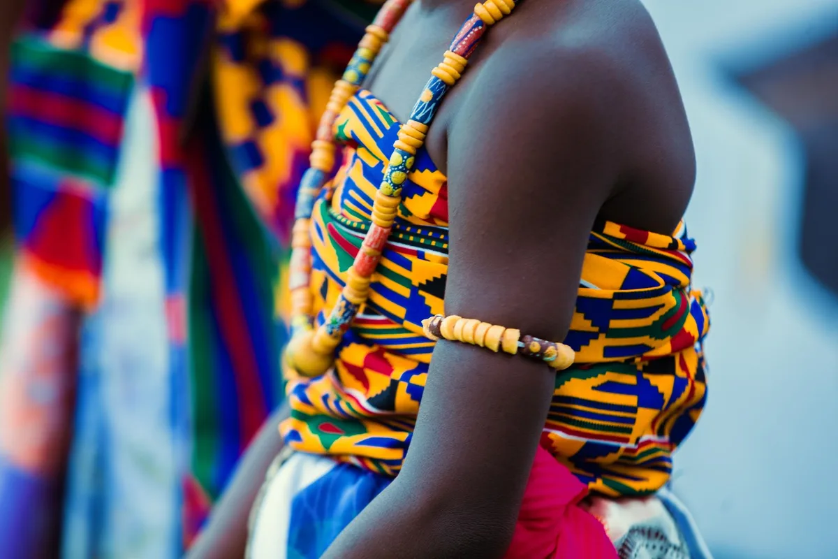 Close-up of vibrant Kente cloth and contemporary African textile designs worn at the wedding