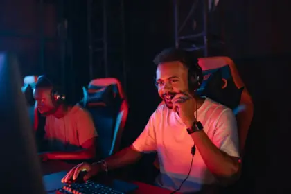 Gaming headset with detachable microphone on desk next to controller and monitor