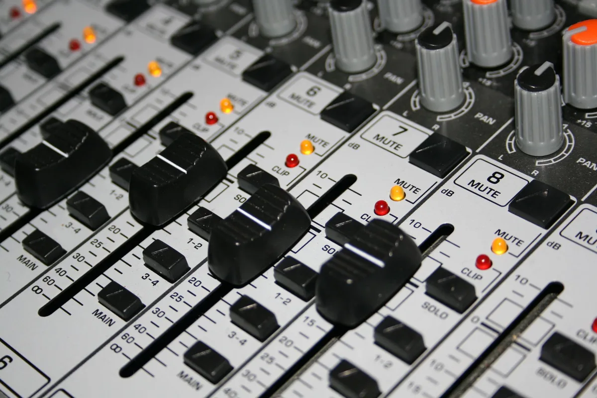 Close-up of a spring-loaded rotary dial control with OLED height display on a gaming desk