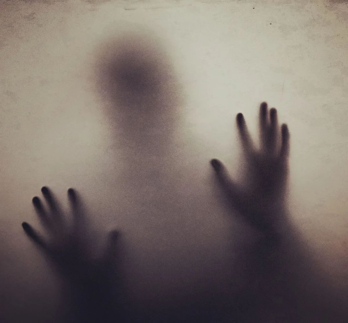 Dimly lit film scene with unsettling practical effects and eerie atmosphere