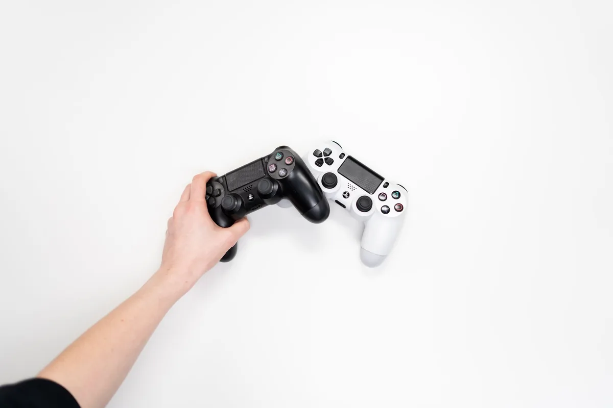 Mobile game controller with tactile face buttons and Hall Effect joysticks attached to a smartphone