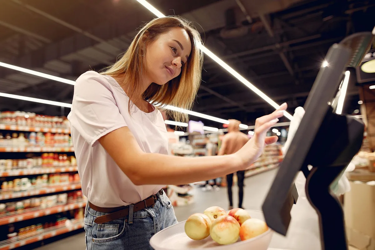 Shopping cart with gaming items and price tags at retail checkout