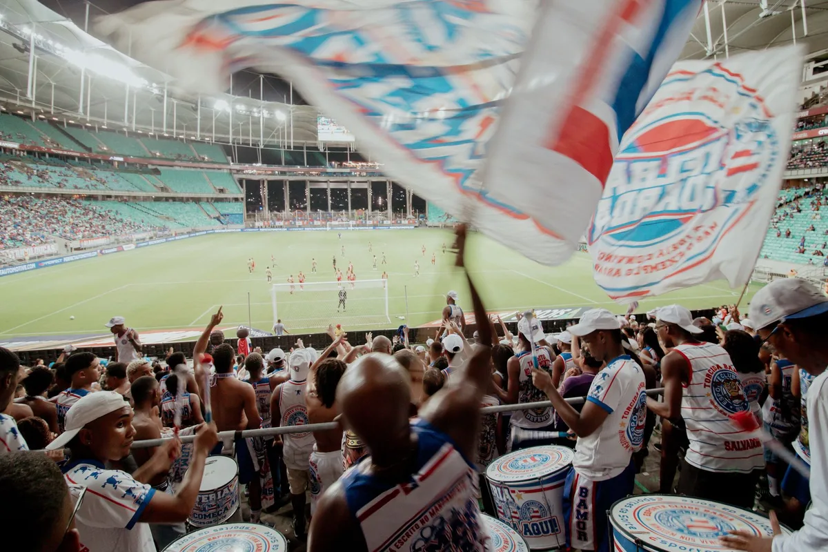 Fans watching a Premier League match live in a stadium