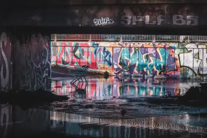 Flooded city streets at night with abandoned buildings and rain-soaked atmosphere