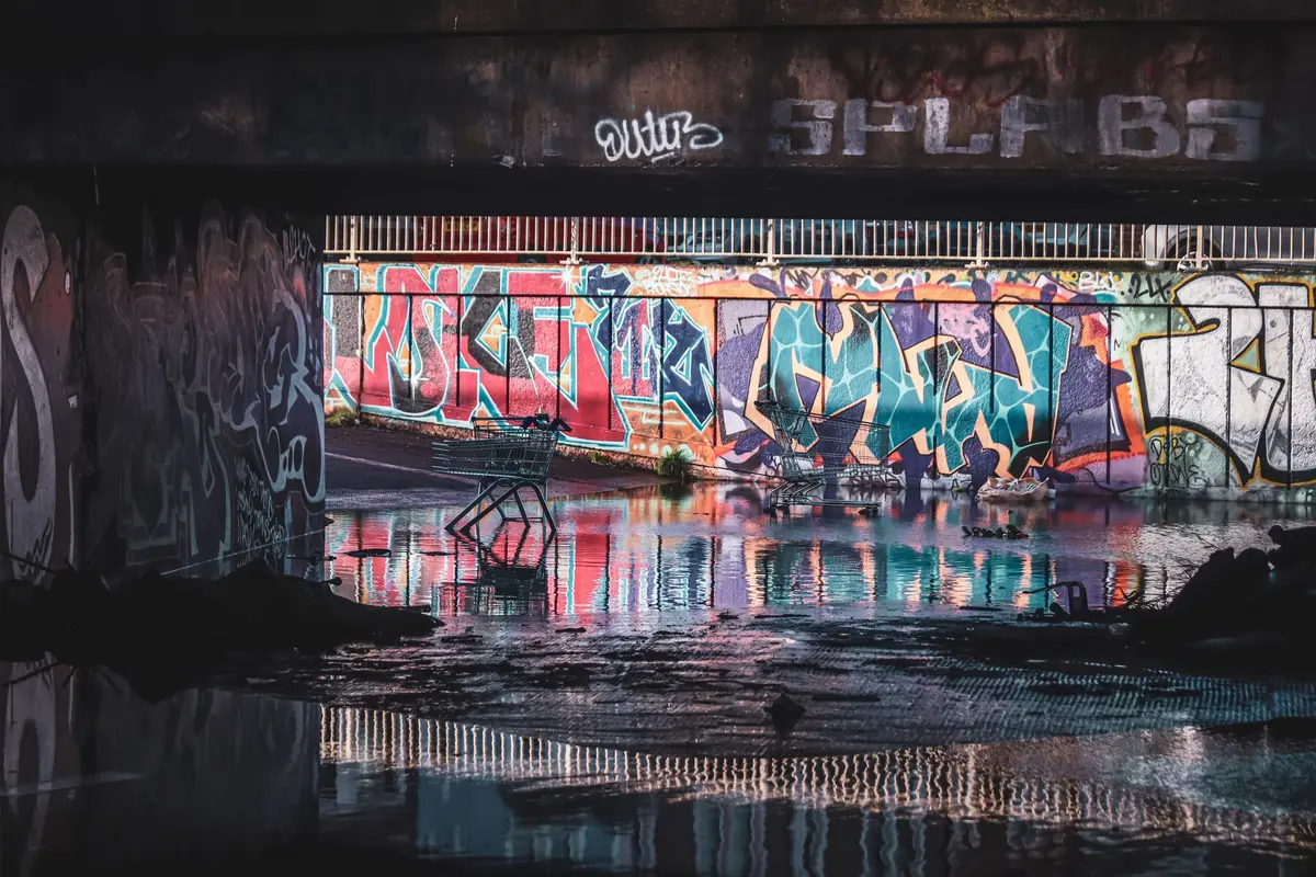 Flooded city streets at night with abandoned buildings and rain-soaked atmosphere