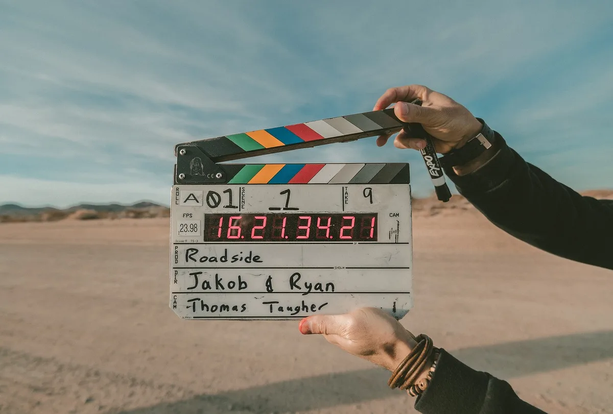 Film clapperboard and empty studio corridor suggesting a sequel in development
