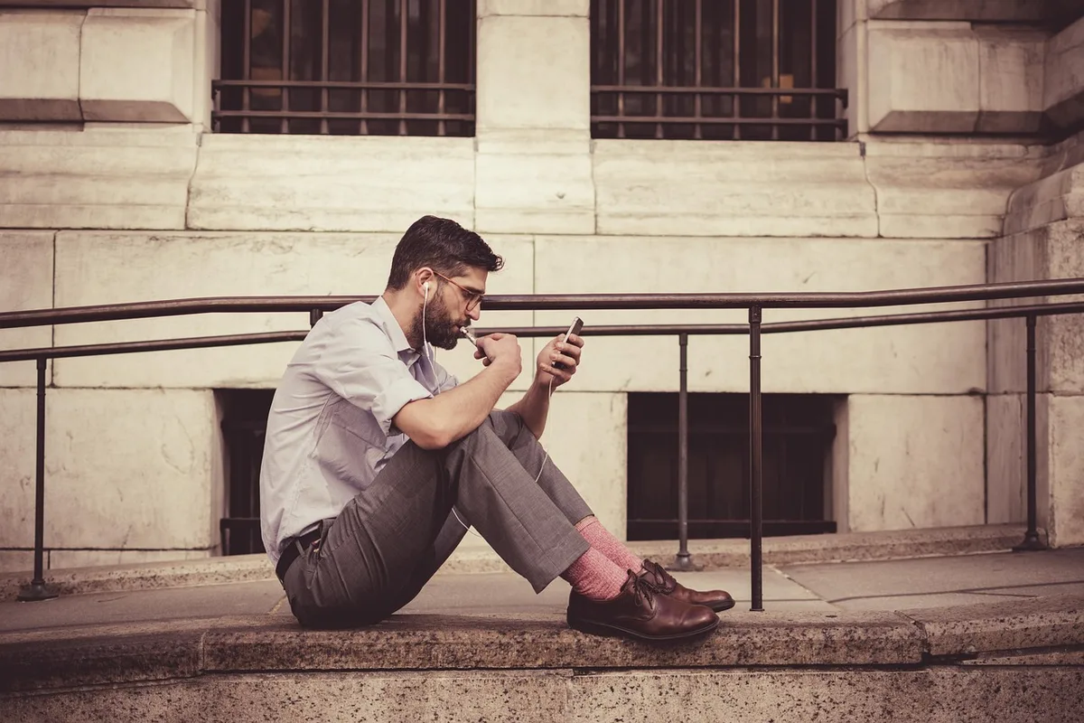 Person answering questions on a smartphone or tablet during an online quiz