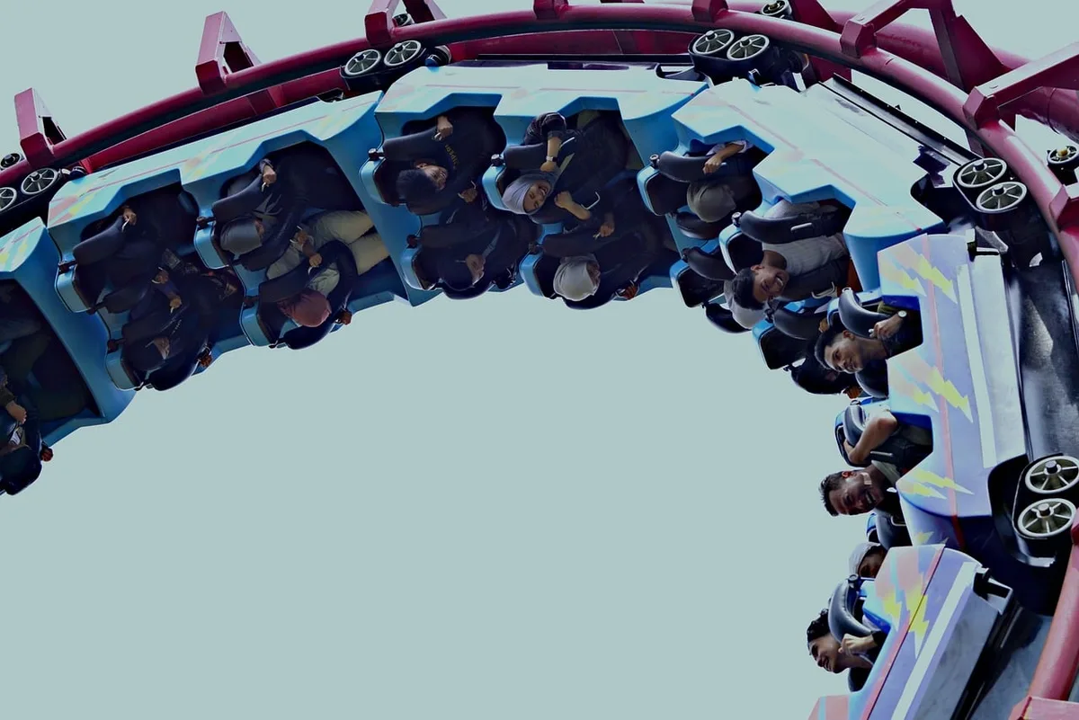 Outdoor roller coaster with desert and snowy mountain terrain themed after Cars franchise