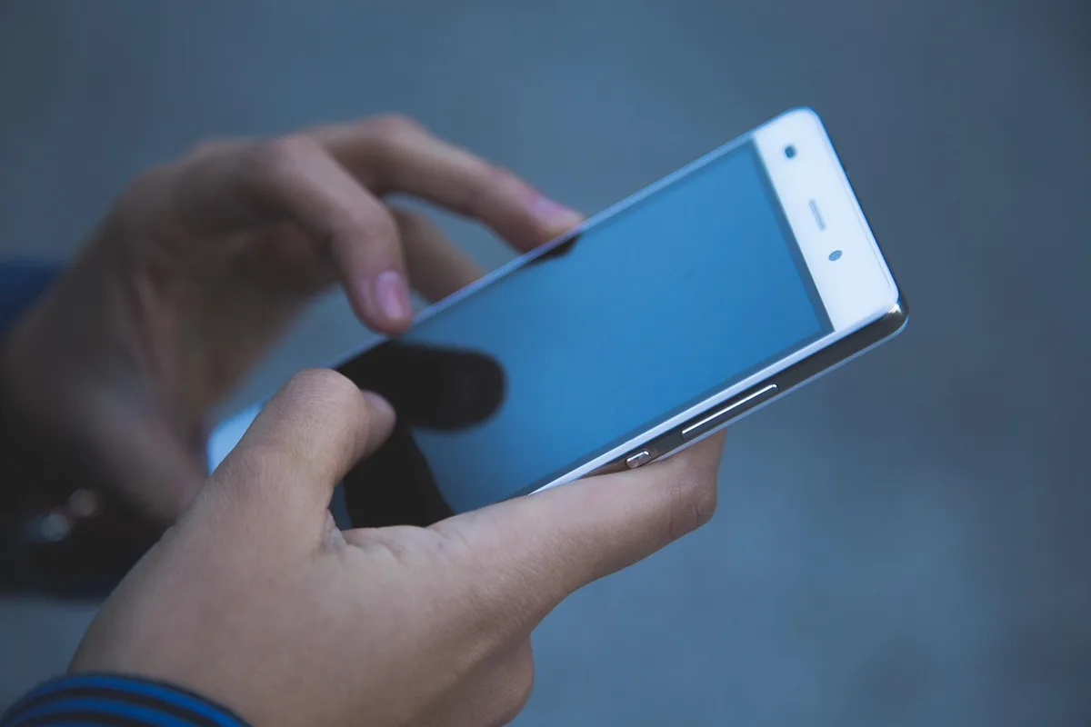 Person holding a premium gaming handheld device with OLED display