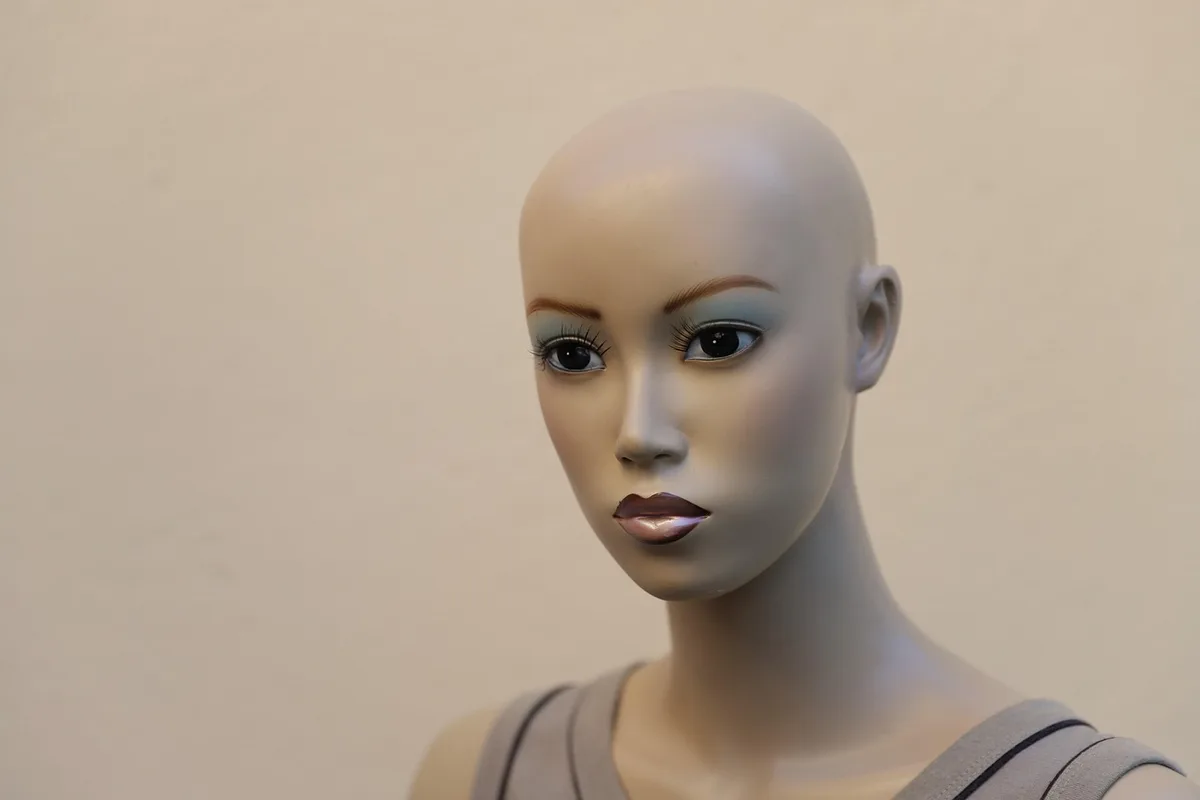 Sunlit newsroom desk with mannequin head wearing a wig and notes, hinting at behind-the-scenes disguises