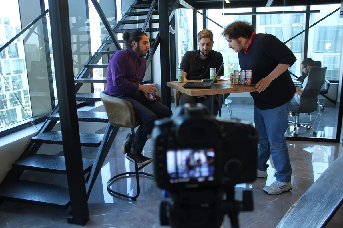 Producers and crew discussing filming schedule around a table