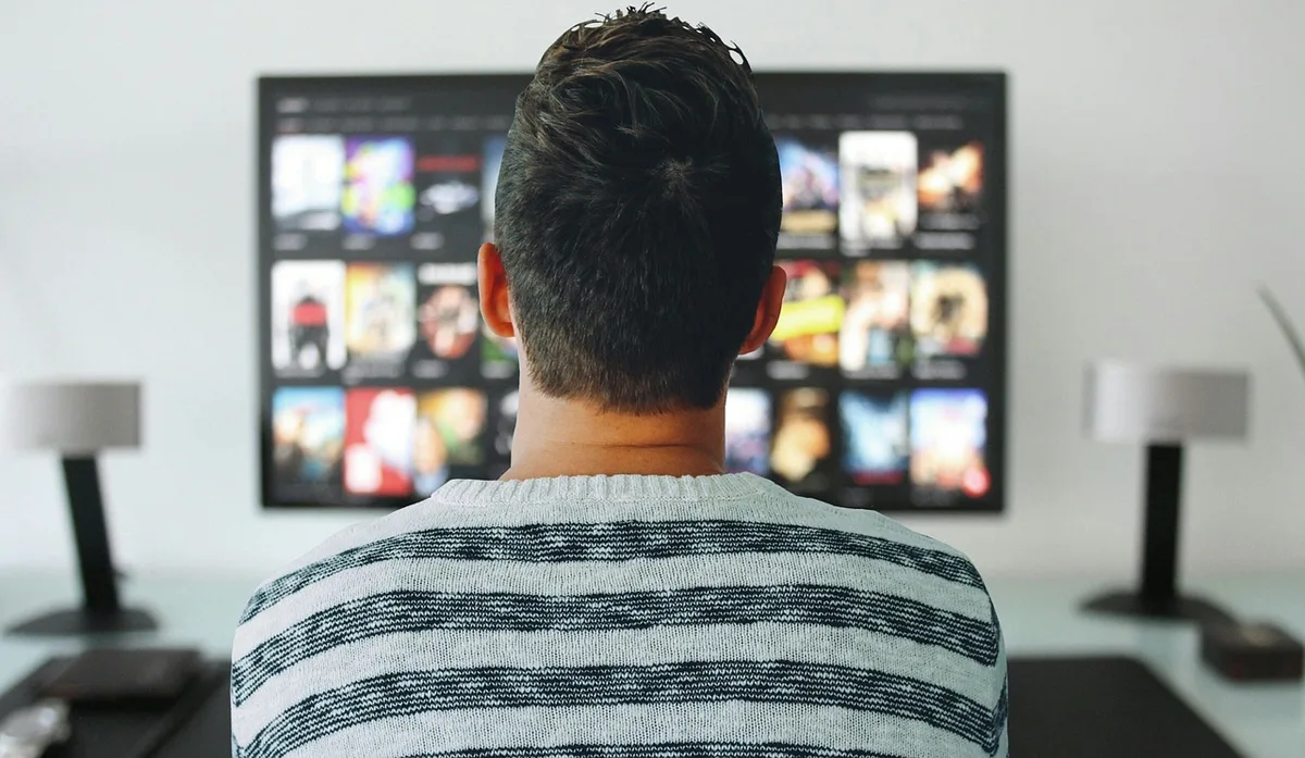 Living room with TV showing a streaming app interface and remote control