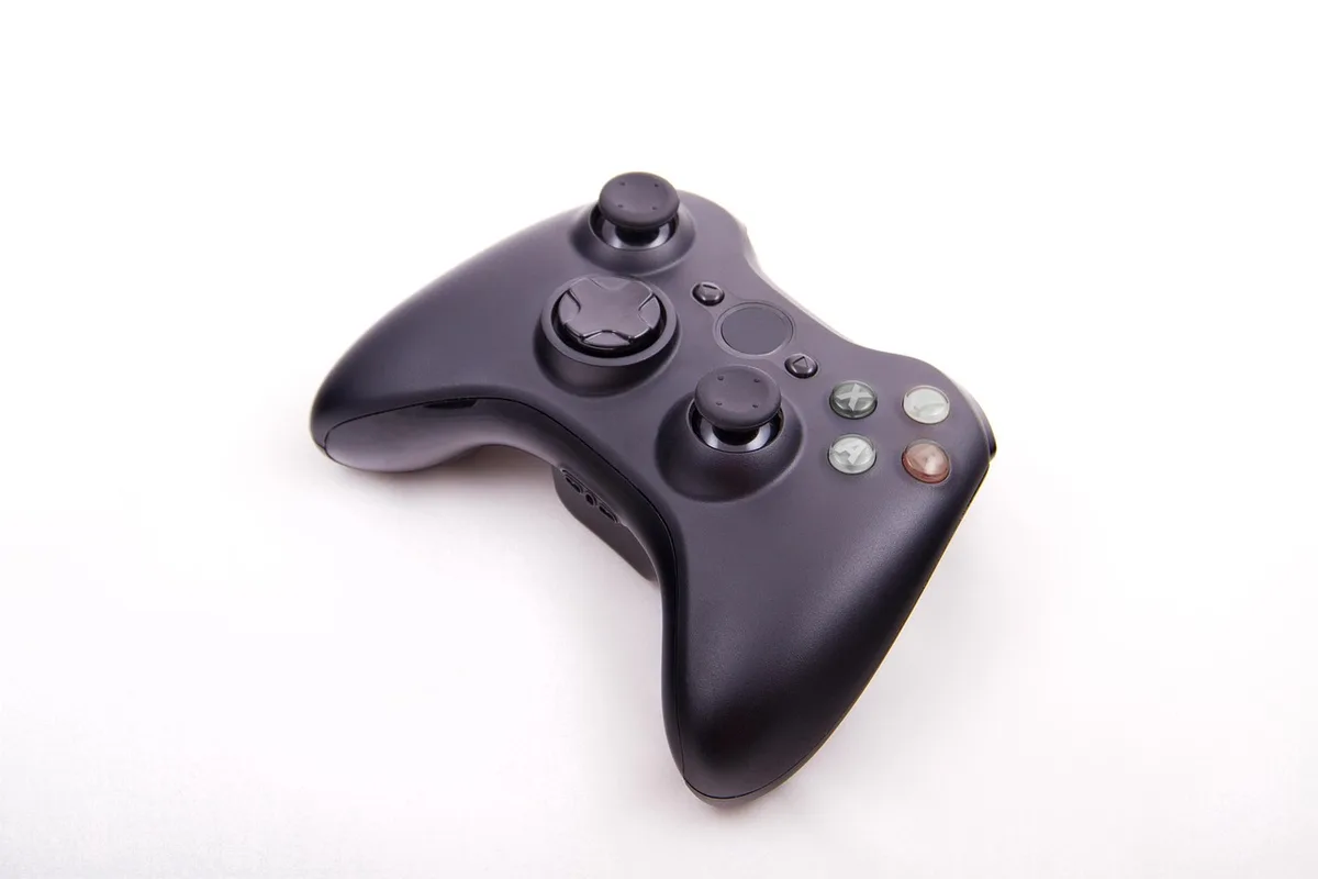 Close-up of a handheld's dual analog sticks and buttons in bright light
