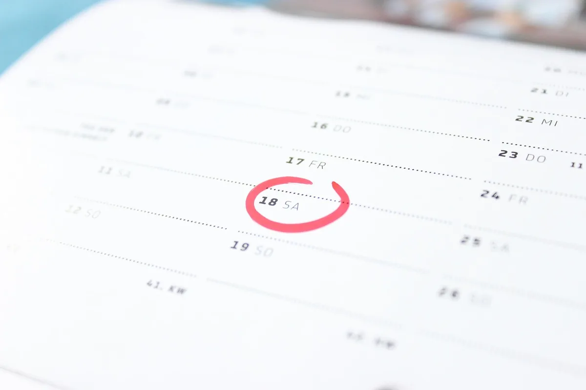 Printed 2026 race calendar pinned to a board with grand prix names