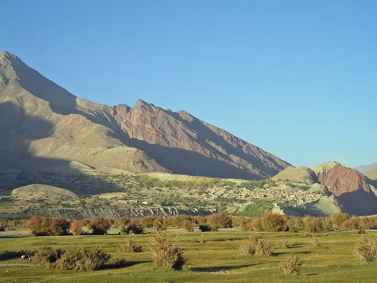 Sunlit eastern foothills with scattered trees and distant ridgelines