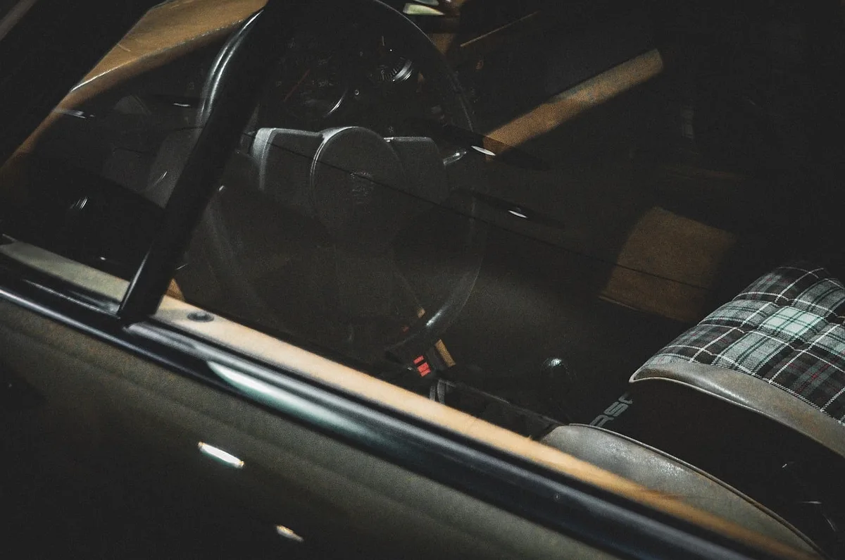 Car keys and dashboard in bright daylight, hinting at vehicle ownership and attachment