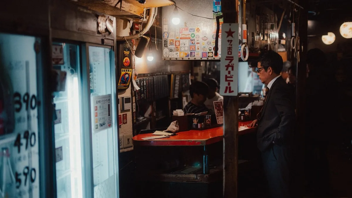 Pub scene showing people talking at a bar during the day