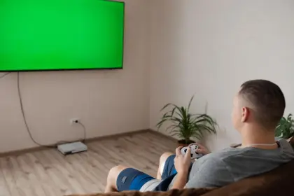 Sunlit living room with game console dock and controllers on a table