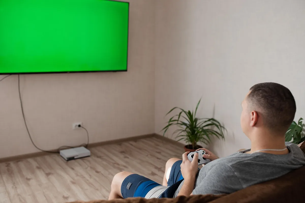 Sunlit living room with game console dock and controllers on a table