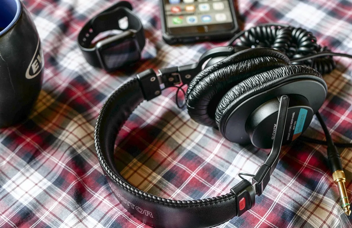 Headset with memory-foam ear cushions on a desk, showing lightweight fit