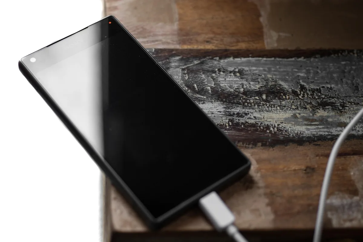 Wireless USB-C dongle beside a headset and charging cable on a desk