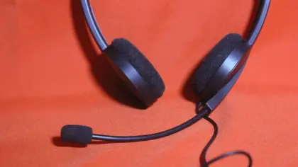 Gaming headset and USB hub on a sunlit desk by a window